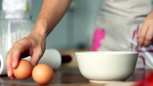 stock-footage-breaking-egg-into-bowl-slow-motion